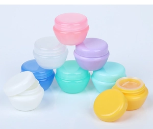 Macro shot of colorful plastic cosmetic cream jars in pink white purple blue and green