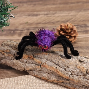Detail of a purple plush spider hair clip with red eyes on natural tree bark decor