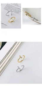 Detail of minimalist S925 silver T-shape open rings in gold and silver with zircon accents