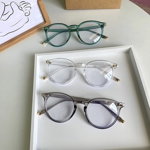 Occhiali retrò anti-luce blu rotondi in verde, trasparente e grigio con rivetti metallici