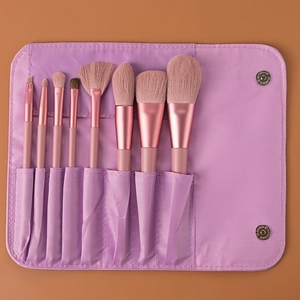 Detail of 8pcs makeup brush set with pink handles in a purple folding travel pouch