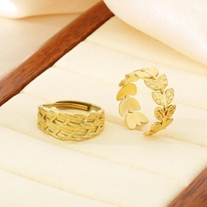 Gold braided texture and leaf pattern adjustable open rings in a jewelry box display