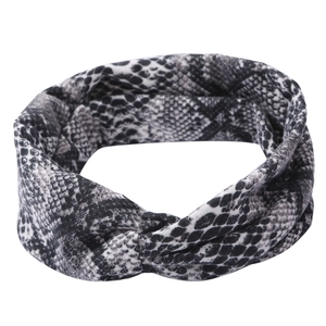 Cross-knot wide sports headband with black and white snakeskin pattern on white background