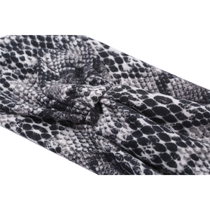 Detail shot of black and white snakeskin print wide sports headband with twist knot detail