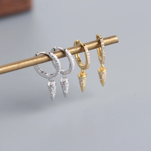 Detailed view of silver and gold conical drop earrings with sparkling pavé zircons