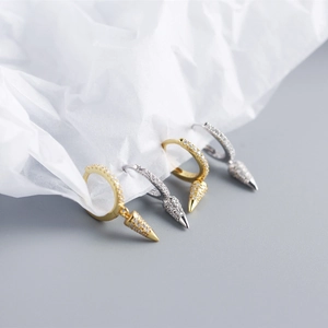 Detailed macro view of S925 sterling silver cone drop earrings with pavé set crystals