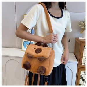 Cute brown plush Capybara crossbody bag shown on a model in a cozy home setting