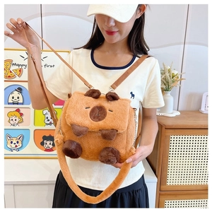 Detail of cute plush Capybara crossbody bag shown on a model in a cozy indoor setting
