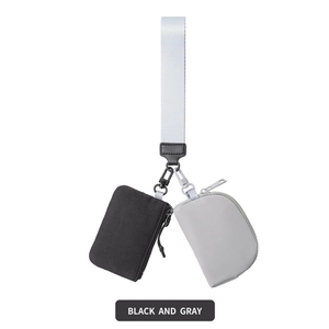 Detail of black and gray nylon wristlet pouches with metal clips and a white strap