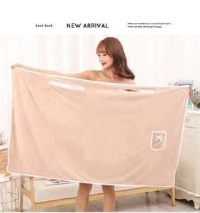 Close-up of thick coral fleece wearable bath towel with arm holes and bow-knot pocket