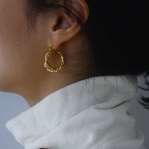 French minimalist S925 sterling silver knot hoop earrings with golden rope texture on ear