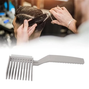 Close-up of a professional grey barber fade comb with an ergonomic curved long handle