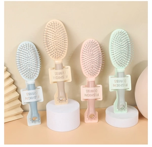 Macro detail of portable hair brushes in pastel colors with soft air cushion bristles