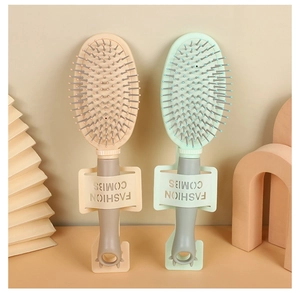 Detail view of beige and light green cushion hairbrushes with matching fashion stands