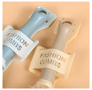 Detail of blue and khaki combs in fashion wall-mounted holders on orange background