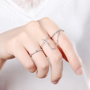 Elegant silver cross ring set with delicate chain connection and sparkling diamond accents