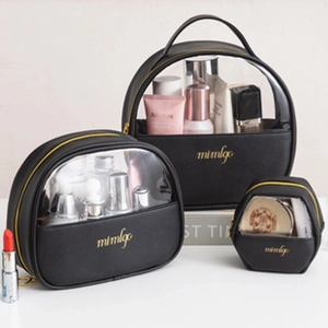 Three-piece set of translucent black waterproof toiletry bags with gold zippers and logos