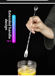 Detail of hand holding a 304 stainless steel long handle cocktail spoon with fork end