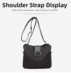 Detail of adjustable strap and silver ring buckle on black nylon crossbody bag