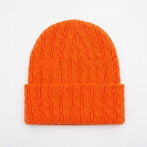Detailed view of the fine knit texture and classic cuffed brim on an orange acrylic beanie