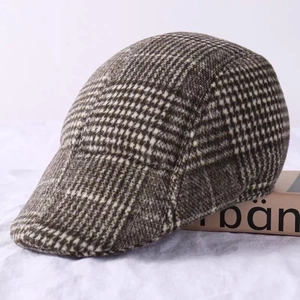 Close-up of brown checkered wool tweed ivy cap showing detailed texture and thick fabric