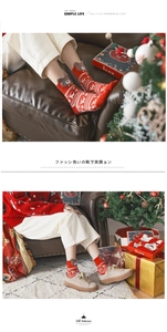 Detail of red Christmas crew socks featuring white reindeer motifs and 3D plush bear ears