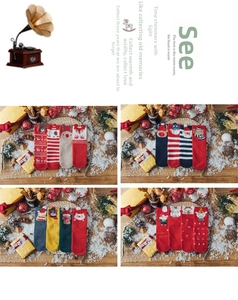 Detailed view of festive Christmas cotton socks with 3D cartoon motifs and holiday gift box