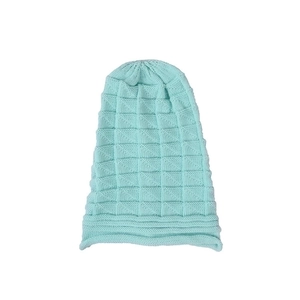 Macro detail of mint green waffle knit texture and rolled brim on a beanie hat