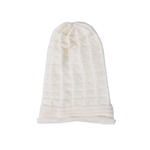 Close-up of white waffle knit texture and rolled edge on this winter beanie hat