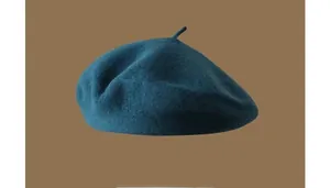 Detail shot of a dark teal Australian wool beret with a retro texture for autumn and winter