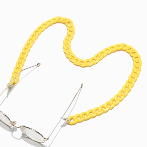Macro view of heart-shaped bright yellow acrylic eyewear chain with metallic frames