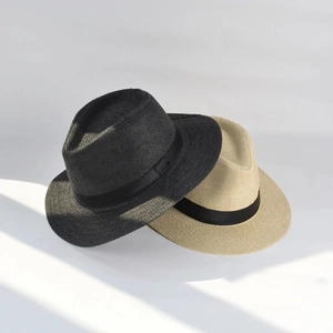 Detail shot of two classic Panama straw hats in beige and dark grey with black bands