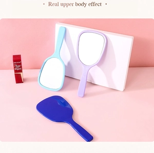 Detailed view of handheld makeup mirrors in light blue, lilac, and dark blue finishes