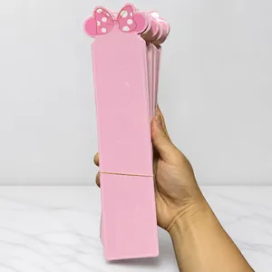 Detail of pink cardboard hair accessory display cards with bow design and slot cutouts