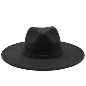 Detailed texture of black wool felt fedora with a wide brim and elegant bow ribbon