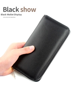 Close-up of black pebble grain leather long wallet with premium metal zipper closure