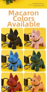 Six colorful silicone French Bulldog keychains with leather straps on a yellow background