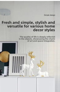 Macro detail of white resin deer figurines with elegant gold antlers for modern home decor