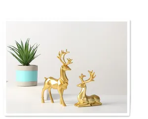 Detail of Nordic golden geometric deer statues with modern poly-facet cutting style