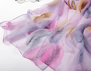 Detail of lavender leaf print chiffon scarf with 100% Silk Feeling material label