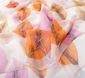 Detailed view of lightweight chiffon scarf featuring vibrant autumn leaf print and hemmed edges