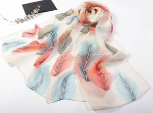 Close-up of semi-transparent chiffon scarf with gradient feather print and rolled edges