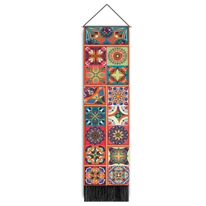 Detail of bohemian wall tapestry with geometric mandala patterns and black tassels