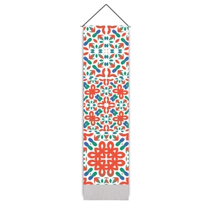 Detail of bohemian geometric tile tapestry with red and blue patterns and bottom tassels