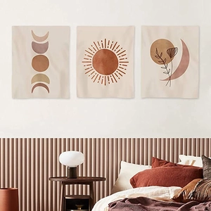 Three-piece bohemian sun and moon wall art set displayed above a cozy bedroom bed