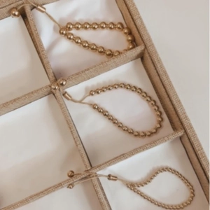 Adjustable gold plated bead bracelets with drawstring slide clasp in jewelry organizer