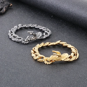 Detail of punk silver and gold titanium steel Cuban bracelets with deer head clasps