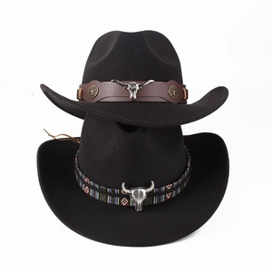 Black felt cowboy hats with cattle skull ornaments and ethnic bands on white background