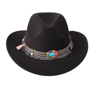 Detail of black cowboy hat with bohemian beads, turquoise stone and colorful tassels