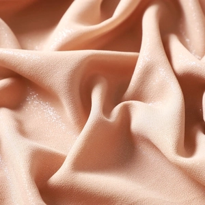 Detailed view of sparkling chiffon fabric with silver glitter specs, soft drape and elegant shimmer.